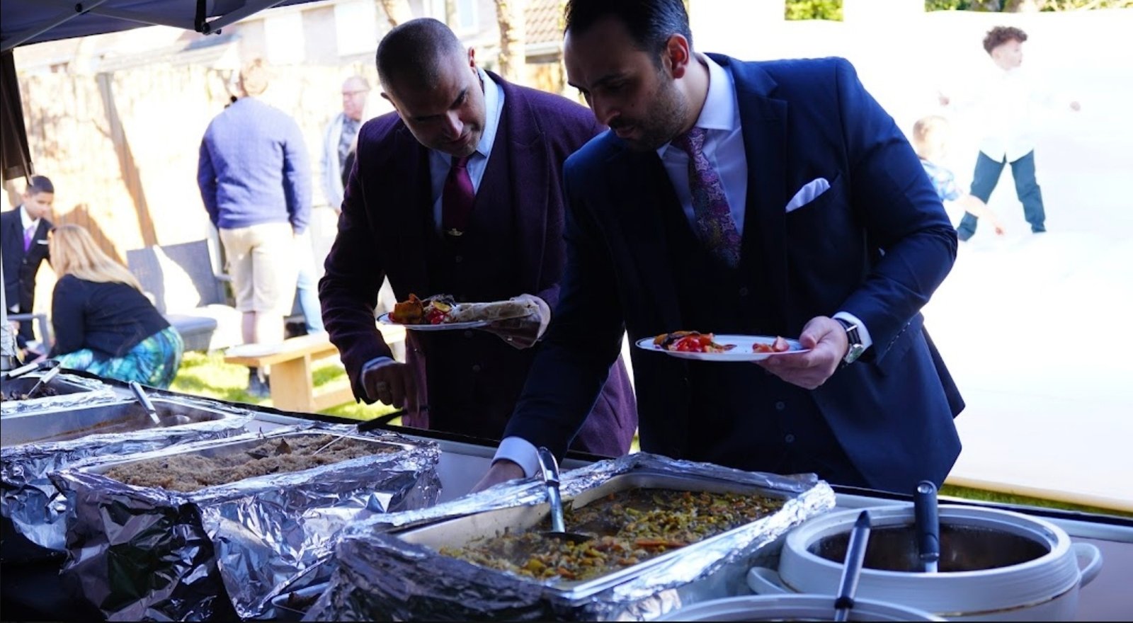 Wedding guests being served at a Grill Seekers buffet